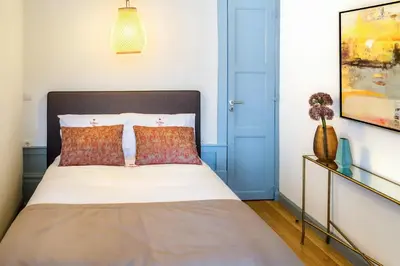 a bedroom with a bed and a blue door at Formosa 168 by Guestify in Porto