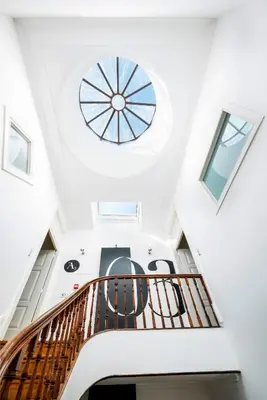 a spiral staircase in a house with a round window at The A5 Smart Luxury Studios in Porto