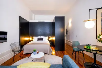 a hotel room with a bed and a couch at The A5 Smart Luxury Studios in Porto