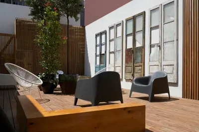 a patio with two chairs and a table at The A5 Smart Luxury Studios in Porto