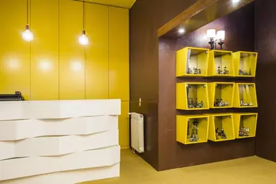 a bathroom with yellow walls and a yellow shelf at Costa do Sol B&B in Porto
