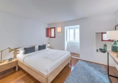 a white bedroom with a bed and a window at Oporto Street das Aldas - River View in Porto