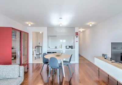 a kitchen and living room with a table and chairs at Oporto Street das Aldas - River View in Porto