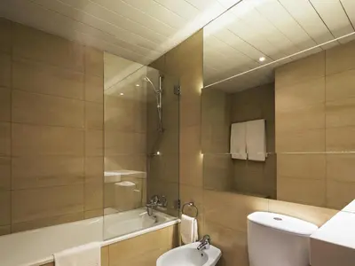a hotel room with a bed and a window at Mercure Porto Centro Santa Catarina in Porto