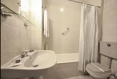 a bathroom with a sink and a toilet and a shower at Hotel Palanca in Porto