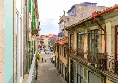 an empty street in a city with buildings at Indulge Porto Flats in Porto