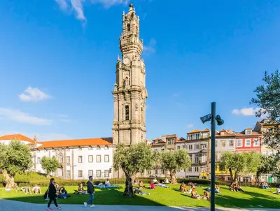 a building with a clock tower in front of a building at Indulge Porto Flats in Porto