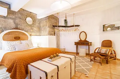 a bedroom with a bed and a table and a chair at Red House 2- With terrace in Porto
