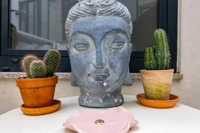 a statue of a head sitting on a table with cactuses at Red House 2- With terrace in Porto