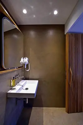 a bathroom with a sink and a mirror at My Story Apartments Porto - Santa Catarina in Porto