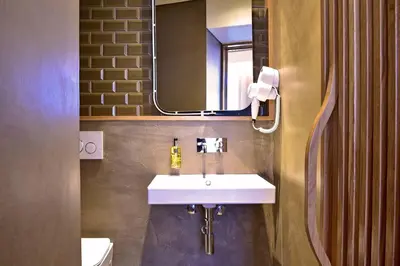 a bathroom with a white sink and a mirror at My Story Apartments Porto - Santa Catarina in Porto