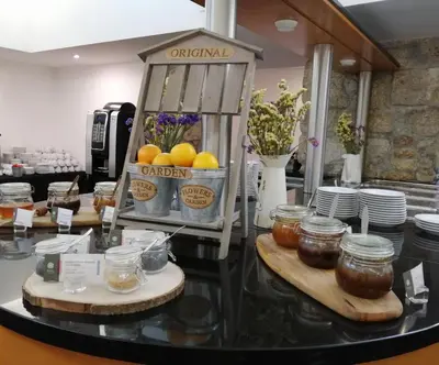 a counter with jars of honey and jars of jam at Legendary Porto Hotel in Porto