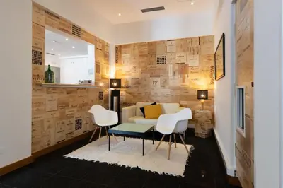 a living room with a couch and a table and chairs at Legendary Porto Hotel in Porto