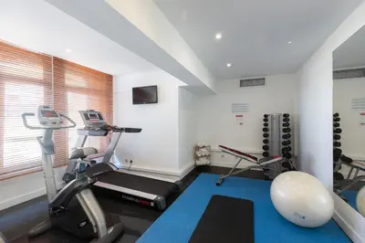 a gym with two exercise bikes and a ball at Legendary Porto Hotel in Porto