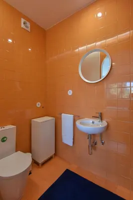 a bathroom with a toilet and a sink and a mirror at Porto Republica Flat in Porto