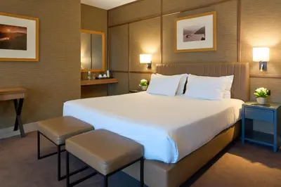 a hotel room with a large bed and a desk at Portus Cale Hotel in Porto