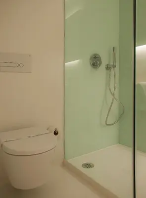 a white bathroom with a shower and a toilet at Boavista Guest House in Porto