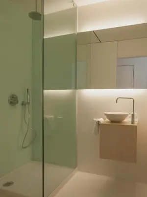 a bathroom with a glass shower with a sink at Boavista Guest House in Porto