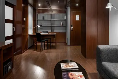 a living room with a desk and a table at AC Hotel Porto by Marriott in Porto