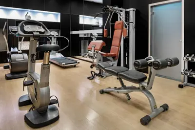 a gym with exercise equipment in a room at AC Hotel Porto by Marriott in Porto