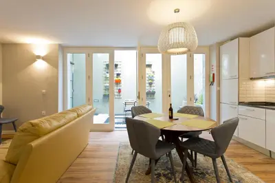a kitchen and dining room with a table and a couch at Duque de Loulé in Porto