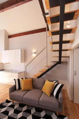 a living room with a couch and a staircase at Duque de Loulé in Porto