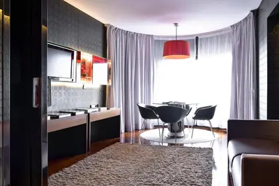 a living room with a couch and a table at Porto Palácio Hotel by The Editory in Porto