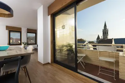 a living room with a large window with a view of a building at LV Premier Marques MQ2 in Porto