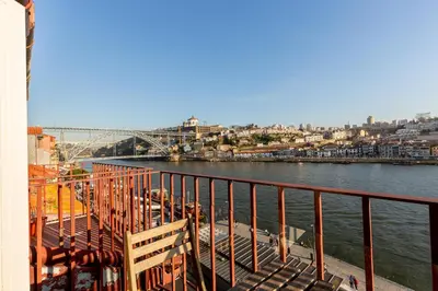 a view of a river with a bridge in the background at YOUROPO - Ribeira Porto in Porto
