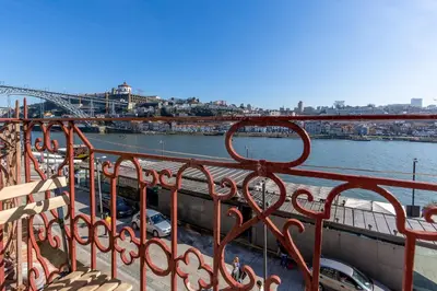 a view of a river with cars parked on a bridge at YOUROPO - Ribeira Porto in Porto