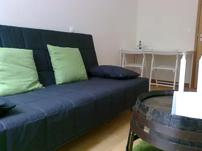 a blue couch with green pillows in a living room at Formosa Oporto Apartments Group in Porto