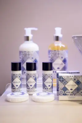 a group of four bottles of soap and toothpaste at Gil Vicente - Charming Guesthouse in Porto