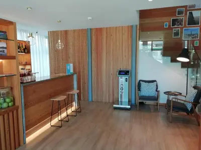 a lobby with a bar and stools in a building at ClipHotel in Vila Nova de Gaia