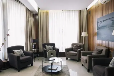 a living room with chairs and a table in a room at Hotel Sao Jose in Porto