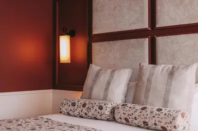 a bedroom with a bed with pillows on it at Gran Cruz House in Porto