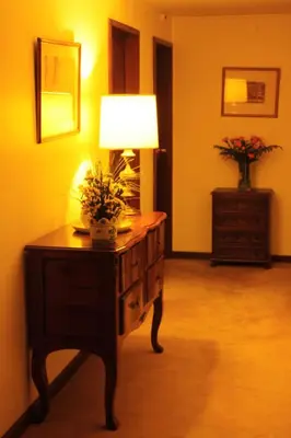 a room with a table with a lamp on it at Hotel Vice-Rei in Porto