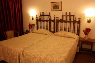 a bedroom with a large bed and two tables at Hotel Vice-Rei in Porto