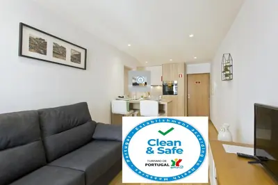 a living room with a couch and a sign for clean and safe at OTF- Porto Centro in Porto