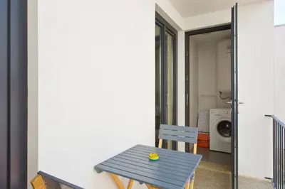 a blue table and chair in front of a house at OTF- Porto Centro in Porto