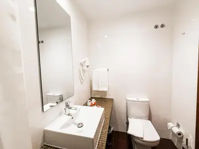 a white bathroom with a sink and a toilet at Stay Hotel Porto Centro Antas in Porto