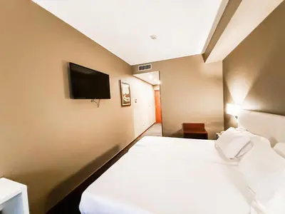 a hotel room with a bed and a flat screen tv at Stay Hotel Porto Centro Antas in Porto