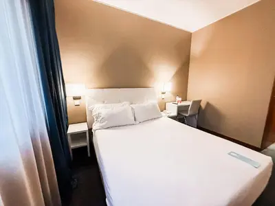 a bedroom with a large white bed with two tables at Stay Hotel Porto Centro Antas in Porto