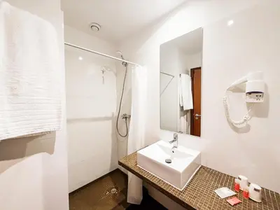 a white bathroom with a sink and a mirror at Stay Hotel Porto Centro Antas in Porto