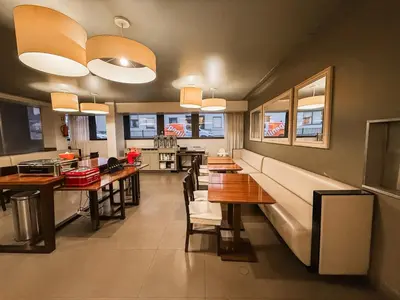 a dining room with tables and benches in a restaurant at Stay Hotel Porto Centro Antas in Porto