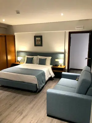 a bedroom with a bed and a couch at Vera Cruz Porto Downtown Hotel in Porto