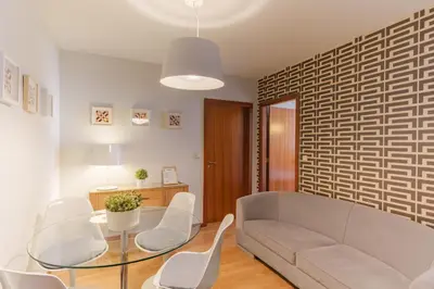 a living room with a couch and a table and chairs at Shining View Apartments in Porto