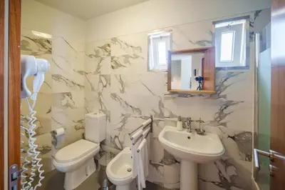 a bathroom with a sink and a toilet and a mirror at Shining View Apartments in Porto