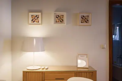 a room with a table with a lamp and a toilet at Shining View Apartments in Porto