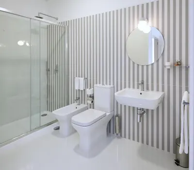 a bathroom with a toilet and a sink and a mirror at The Rex Hotel Porto - Mansion House - Private Parking in Porto