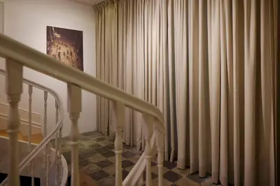 a room with curtains and a staircase with a stair case at Cale Guest House in Porto